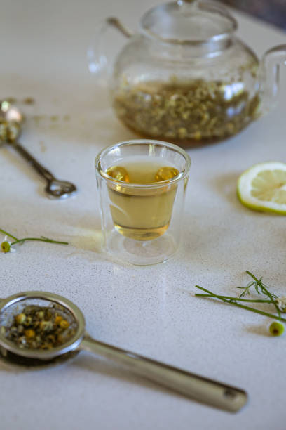 istock Side angle shot of camomile tea preparation in kitchen with copy space 1302806594