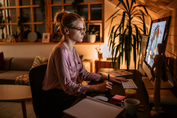 istock Young woman graphic designer works during night 1302806702