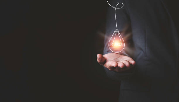 istock Businessman holding glowing lightbulb and using computer laptop to input business strategy idea , creative thinking ideas and innovation concept. 1302807464
