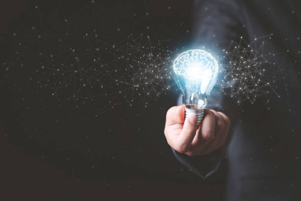 istock Businessman holding glowing lightbulb with drawing brain and connection line, creative thinking ideas and innovation concept. 1302807641