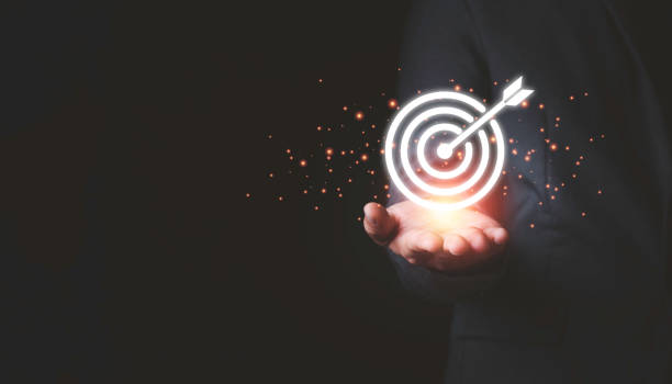 Businessman holding virtual  dartboard and arrow with copy space for setup business objective target concept.