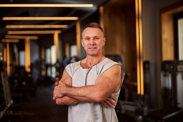 istock Midlle-aged man in workout tank top posing for camera 1302809410