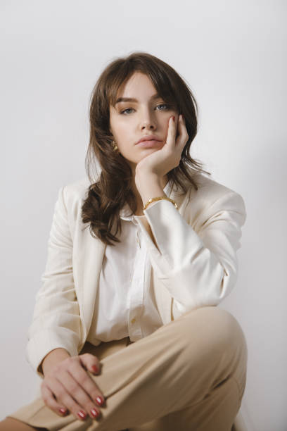 istock Lady in White Suit On Bright Background 1302809591