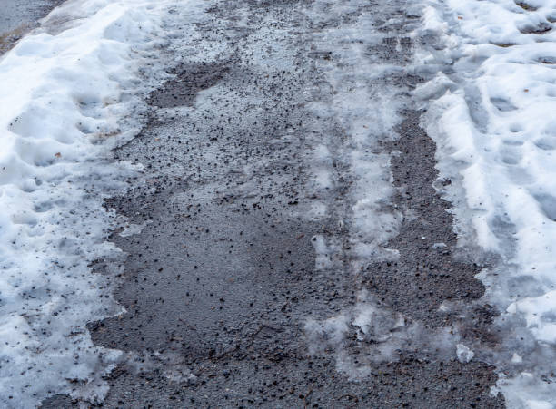 istock icy footpath in winter in a city 1302810182