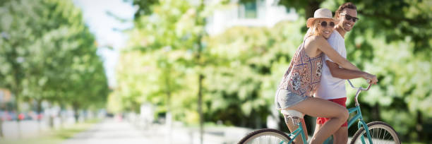 istock Composite image of cute couple on a bike ride digital composite image 1302814520