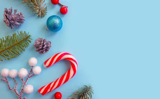 istock Christmas tree branch, candies on a colored backgroun 1302814618
