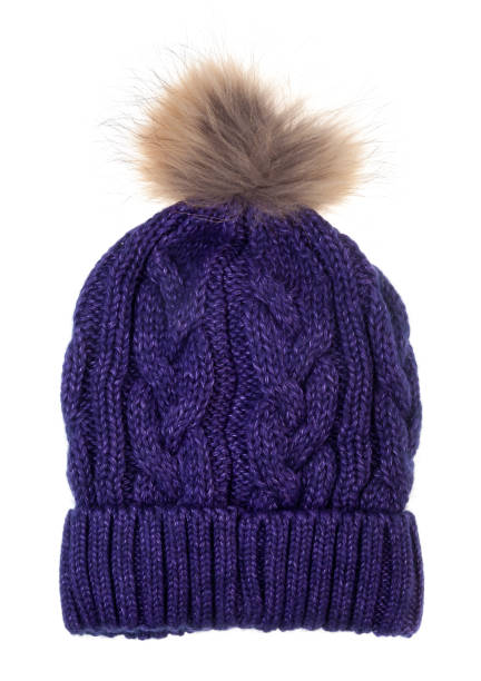 istock Knitted winter bobble hat with cable knitting ornament isolated on white 1302814815