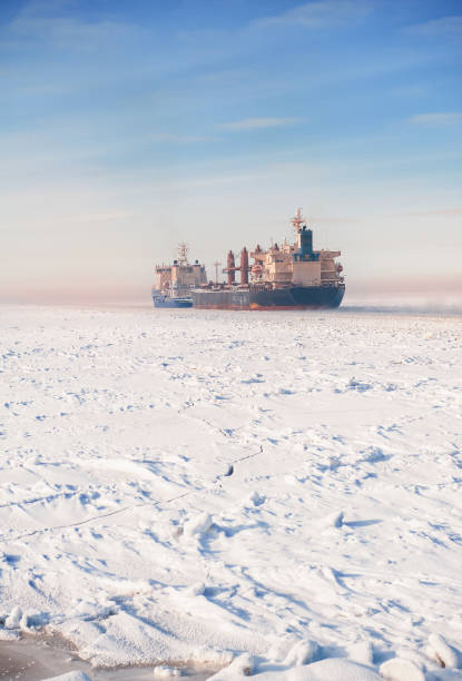 istock Big cargo ships in frozen ice sea fairway 1302814829