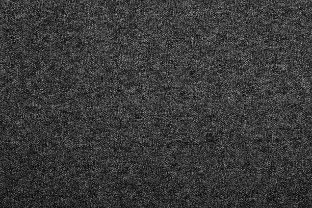 Heather grey knitted fabric textured background Heather dark grey knitted fabric made of melange mixed yarn textured background heather stock pictures, royalty-free photos & images