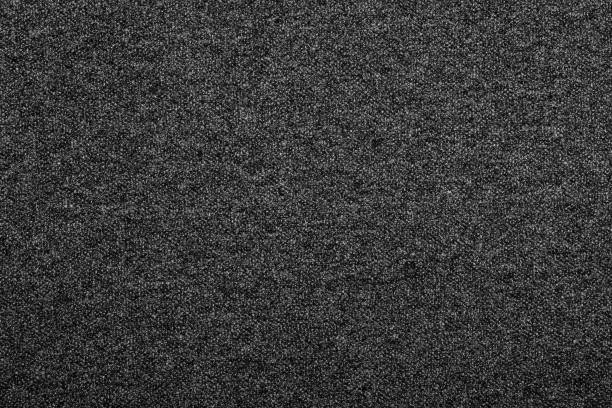 Heather grey knitted fabric textured background Heather dark grey knitted fabric made of melange mixed yarn textured background heather grey stock pictures, royalty-free photos & images