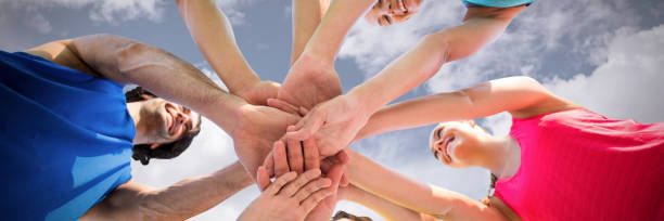 istock Composite image of low angle view of friends huddling 1302816365