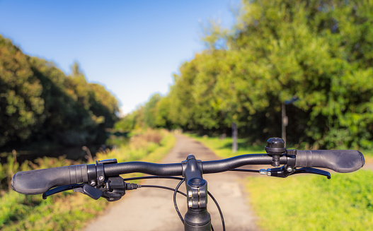 A cyclist's point of view on a canal towpath in Glasgow, Scotland.