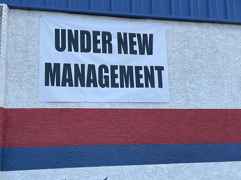 Under new management sign