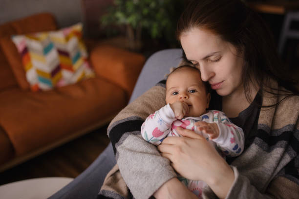 istock Mom cuddling with her daughter 1302820391
