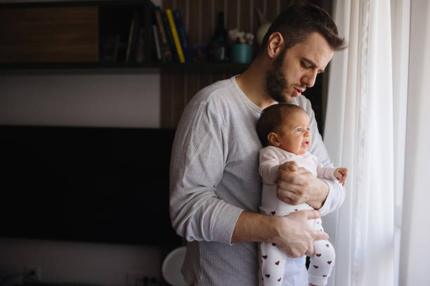 istock Dad holding his newborn daughter 1302820516