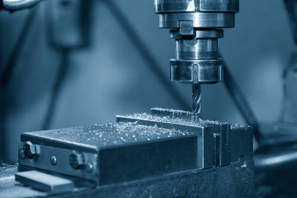istock The NC milling machine drilling  at the metal part by flat drill tools. 1302820562