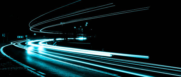 istock blue car lights at night. long exposure 1302820610