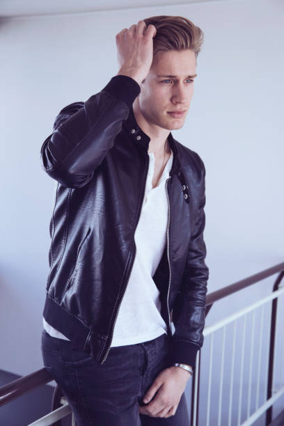 He looks off towards distant scene
