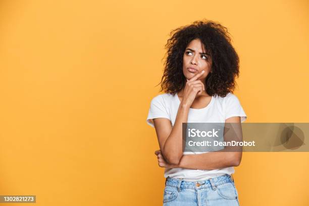 Portrait Of A Thoughtful Young African Woman Stock Photo - Download Image Now - Contemplation, African Ethnicity, Women