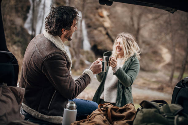 istock Couple hikers drinking tea in nature 1302822389