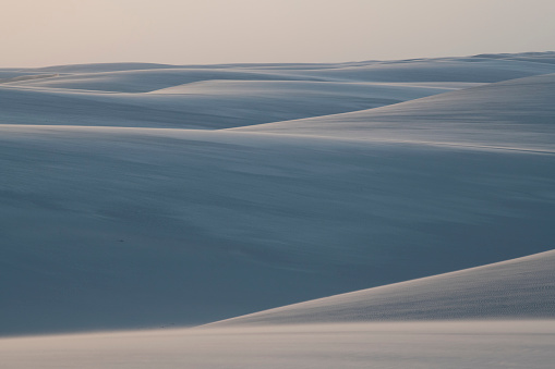 different sized dunes in the sunset produce a maze of sand paths. photo taken in lençóis maranhenses