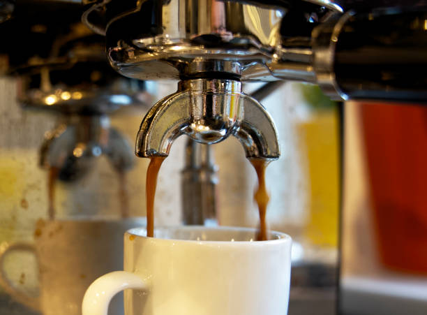 istock Close up of brewing a fresh espresso with a piston machine 1302822688