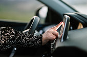 Woman touching the touch screen of a car