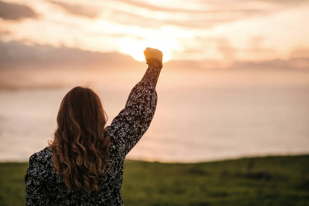 istock Young woman with high fist 1302825134