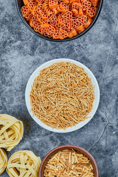 istock Various types of dry pasta on the marble background 1302825369