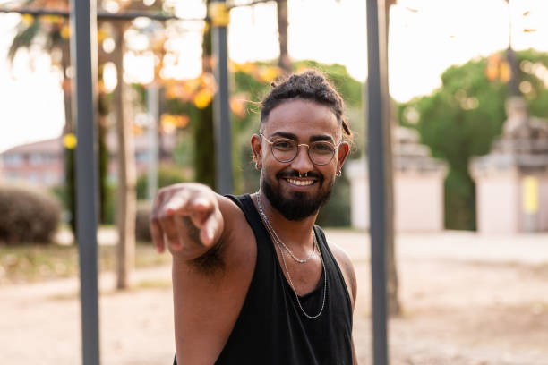 istock african american athlete boy greets smiling camera in a park. 1302829372