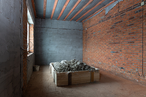 construction mix in a wooden bunker inside a private house under construction without people