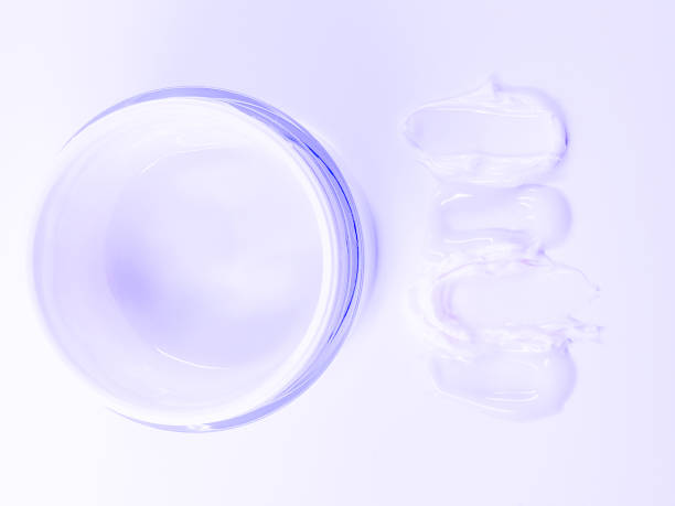 istock Face cream with colored texture smudges, cosmetics background,  fluid cream, liquid consistency skin care 1302829668