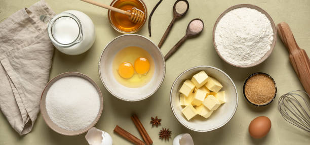 istock Baking background banner. Baking ingredients: flour, eggs, sugar, butter, milk and spices. Top view. 1302830531