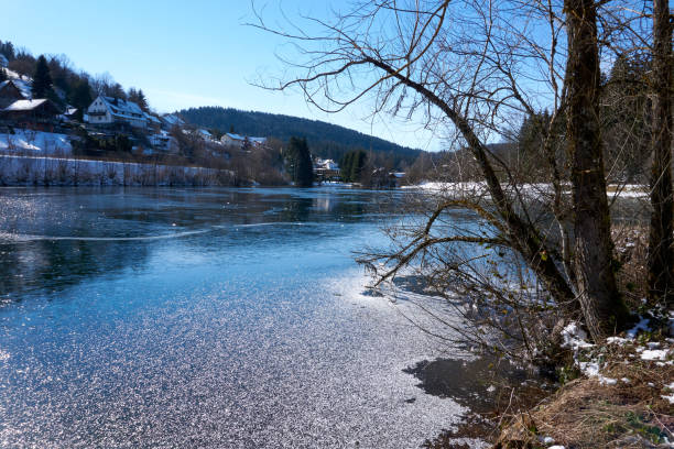 istock partially frozen river with snow and ice under a blue sky 1302830642