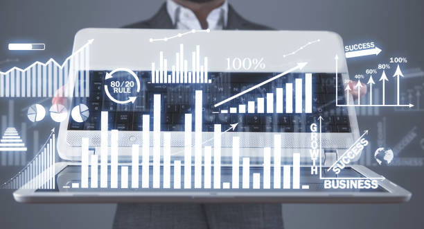 istock Businessman holding laptop with a growth graphs. Business. Development. Success 1302830828