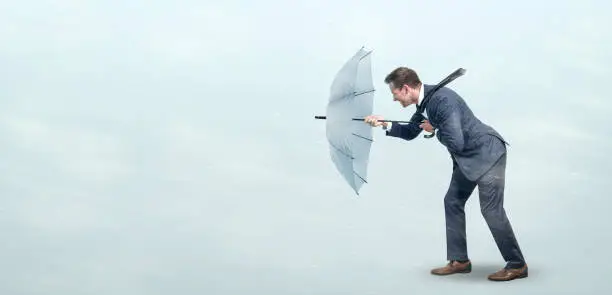 Photo of Businessman defying strong headwind