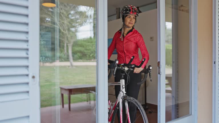 Hispanic Female Triathlete Leaving Home for Workout on Bike