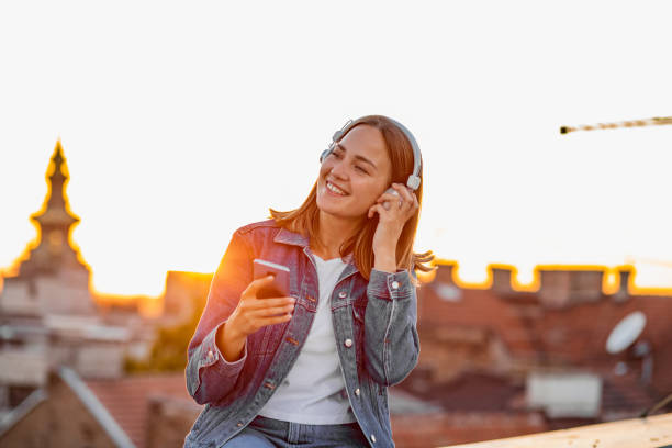 istock Young modern woman on the rooftop during sunset 1302832336