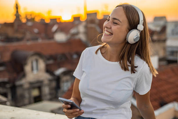 istock Young modern woman on the rooftop during sunset 1302832603