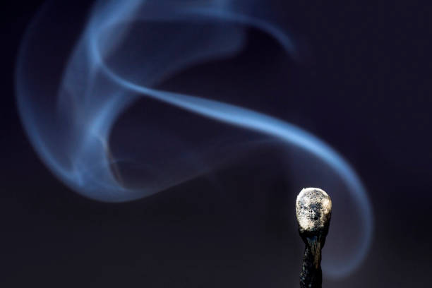istock Smoke coming from an extinguished match on a black background 1302832646