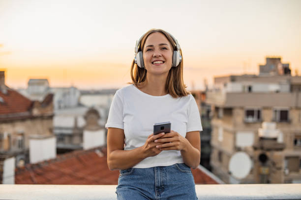 istock Young modern woman on the rooftop during sunset 1302832754