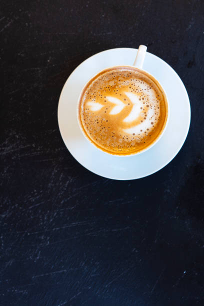 istock Cup of coffee in black background with copy space 1302836898