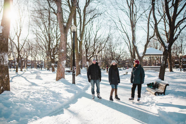 istock Three people ice-skating on a ice rink 1302839002