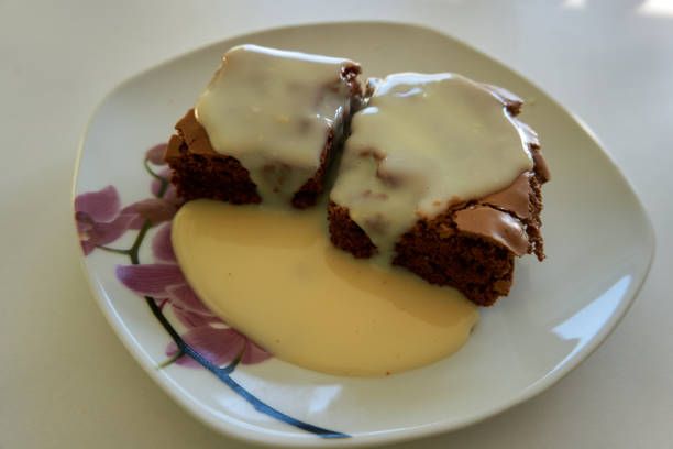 istock plate with 2 brownies and vanilla sauce 1302839177