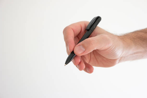 istock Black plastic ball pen held in hand by Caucasian male hand making gesture studio shot isolated on white 1302841672