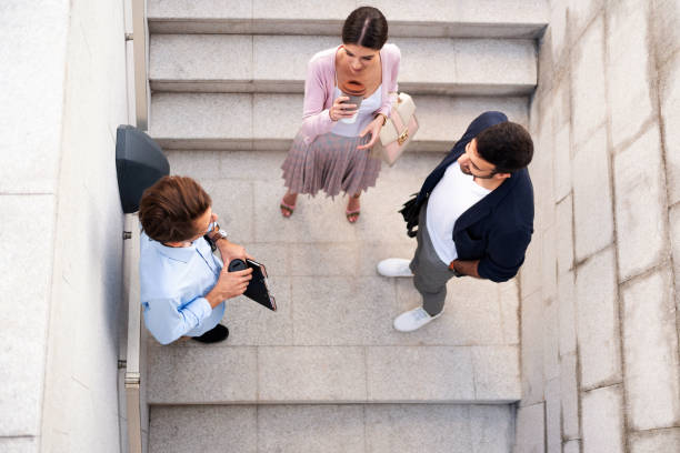 istock Top view of young people talking outside the office 1302844601