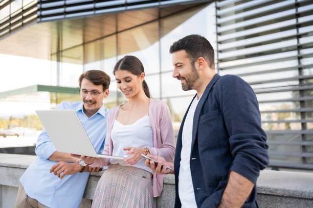 istock Three young coworkers looking at the project on a  laptop together 1302844686