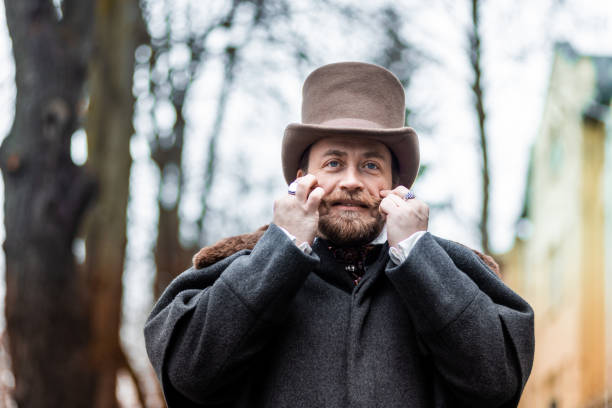istock Respectable mustachioed man in classic retro clothes, coat and hat. 1302844787