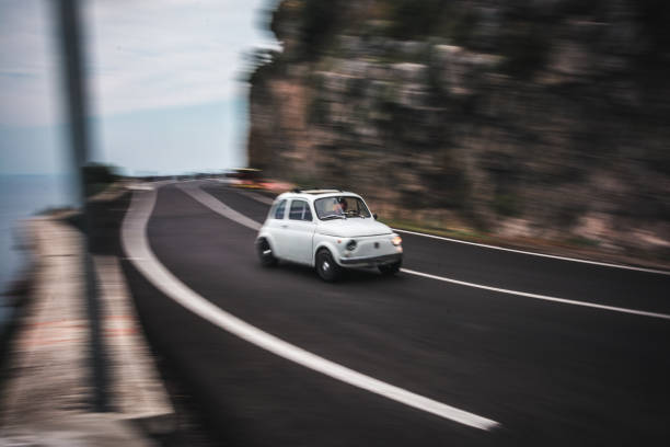 istock Oldtimer car motion on winding coastline road 1302847142