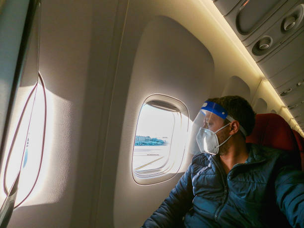 istock Airplane passenger complying with the protocols established against COVID-19 1302847886